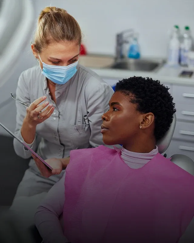 A dentist discussing treatment with a patient
